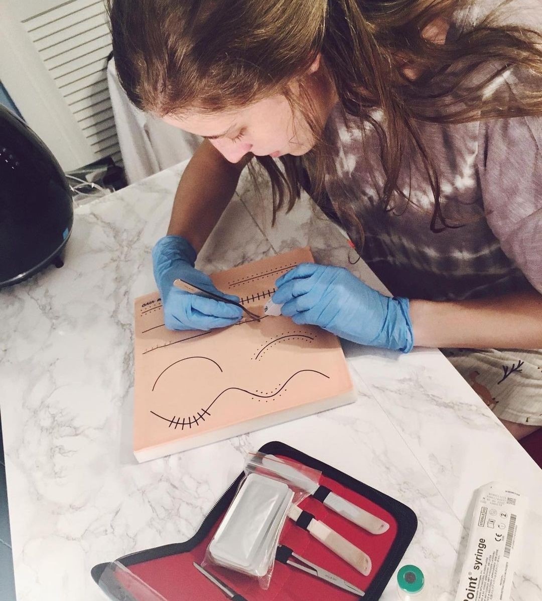 Student Practicing on Sim*Suture